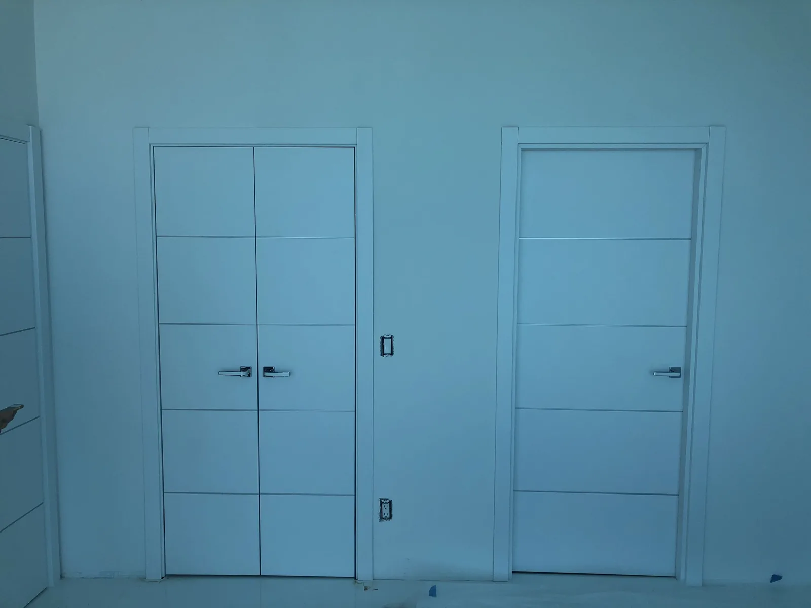 White doors with slim aluminum inlays — interior door supplied and installed by Slab & Trim