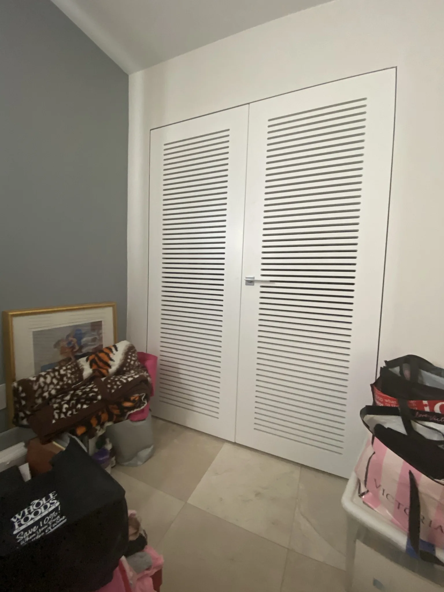 White louvered closet doors — interior door supplied and installed by Slab & Trim