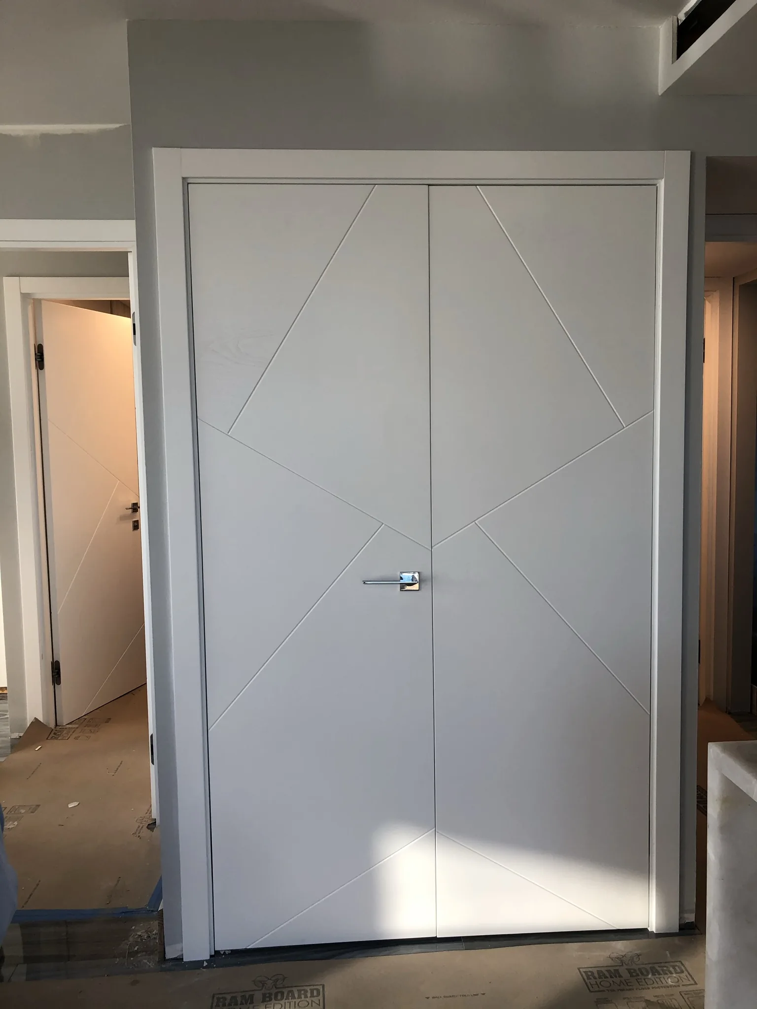 White double door with a diagonal groove pattern — interior door supplied and installed by Slab & Trim