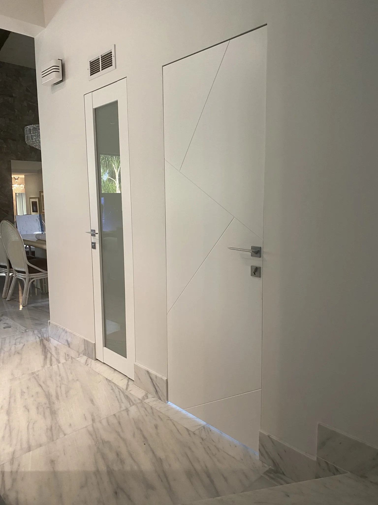 White door with a glass insert and geometric groove — interior door supplied and installed by Slab & Trim