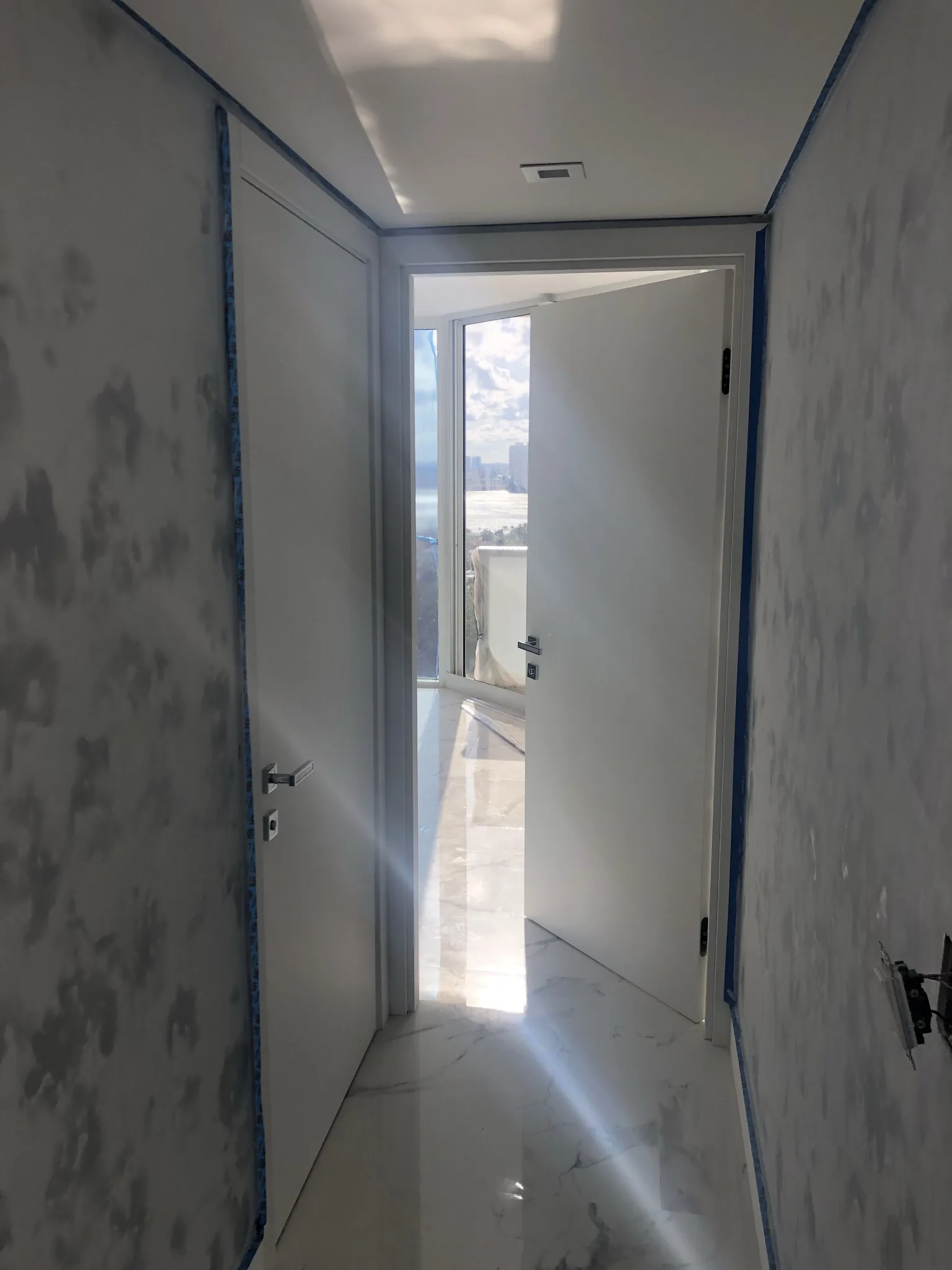 White flush door in a hallway — interior door supplied and installed by Slab & Trim