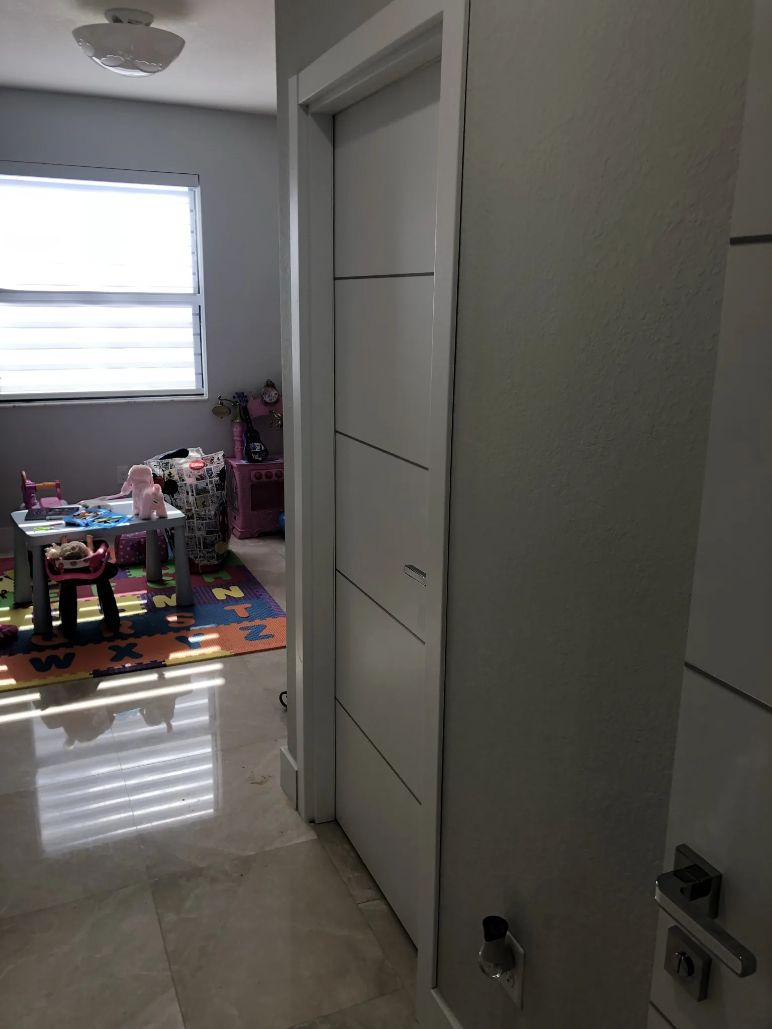 Grey woodgrain door with vertical grooves — interior door supplied and installed by Slab & Trim