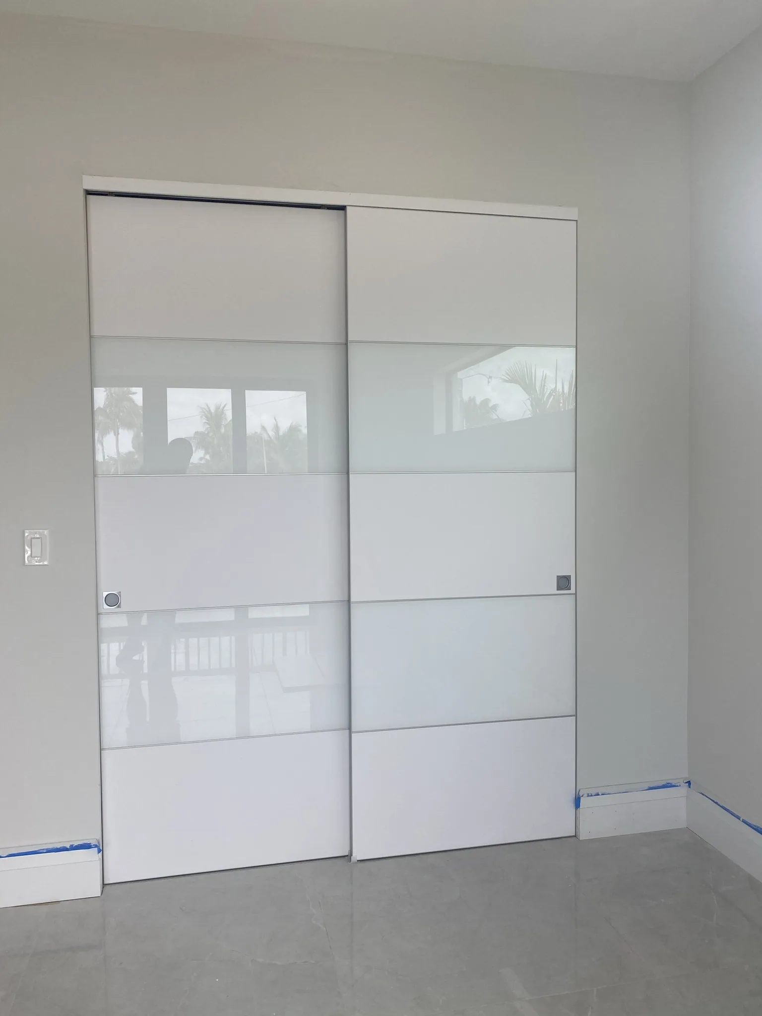 White sliding door with a glass panel — interior door supplied and installed by Slab & Trim