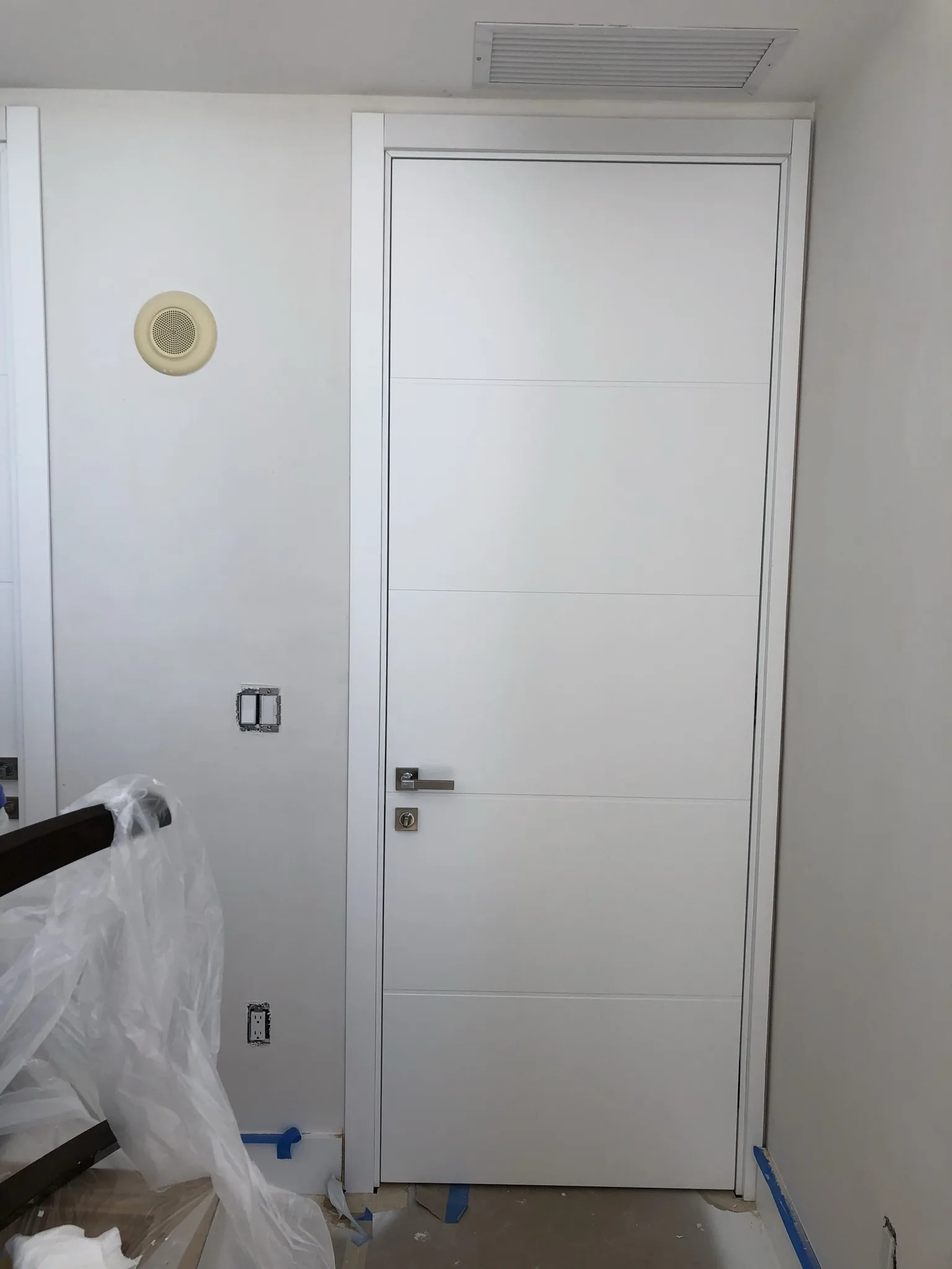 White door with horizontal aluminum inlays — interior door supplied and installed by Slab & Trim