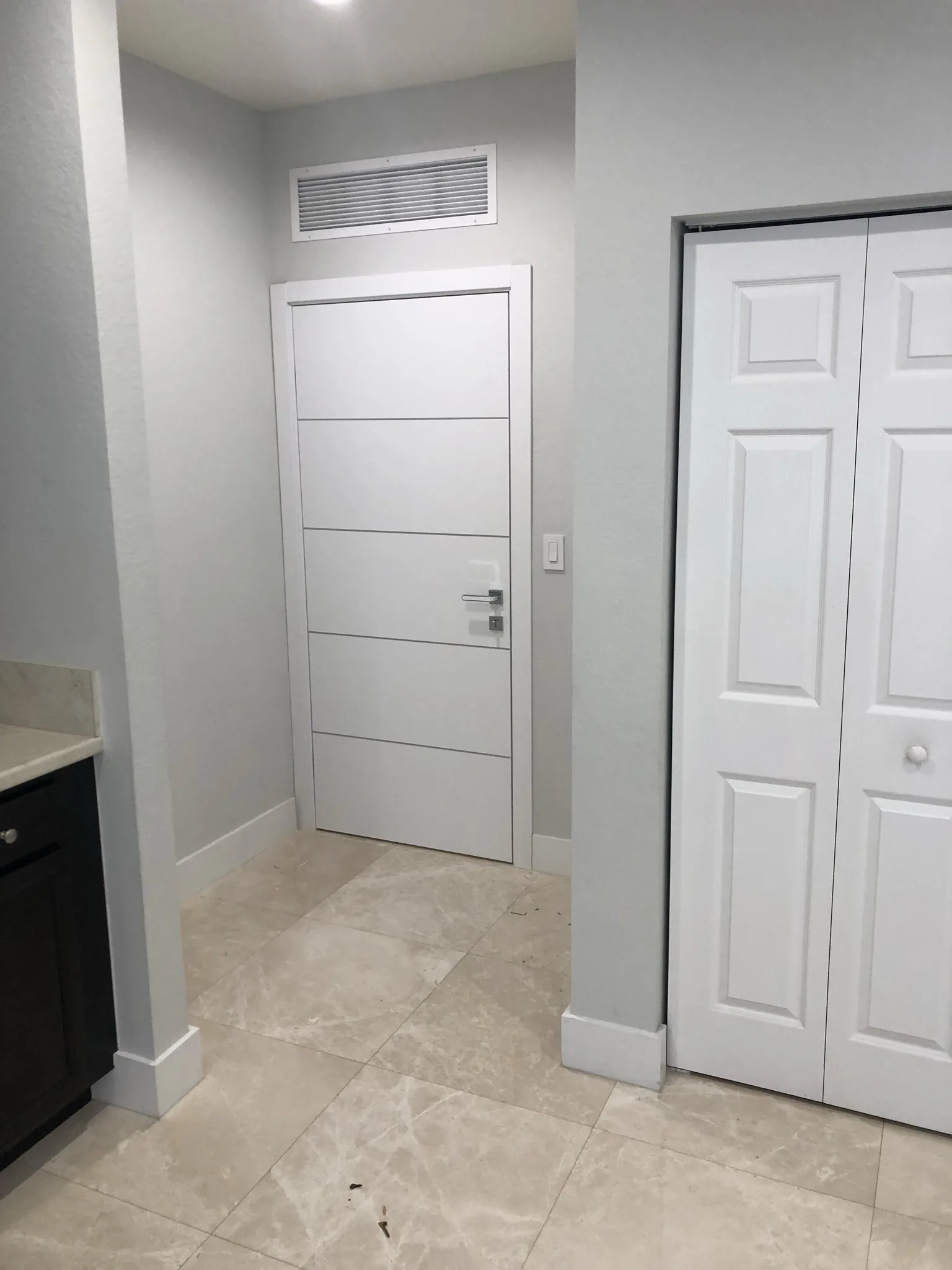 White modern door with horizontal grooves — interior door supplied and installed by Slab & Trim