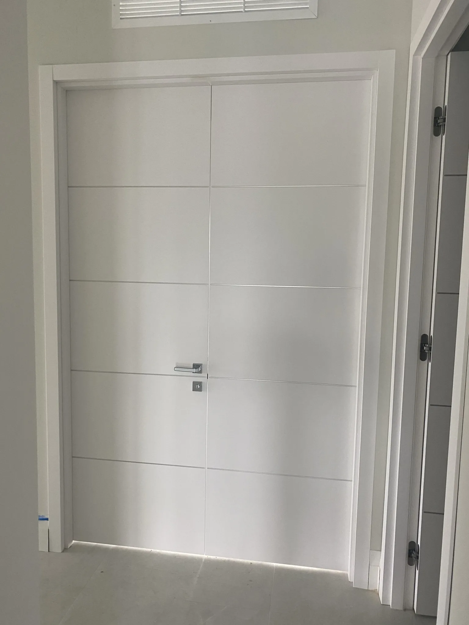White double door with horizontal grooves — interior door supplied and installed by Slab & Trim