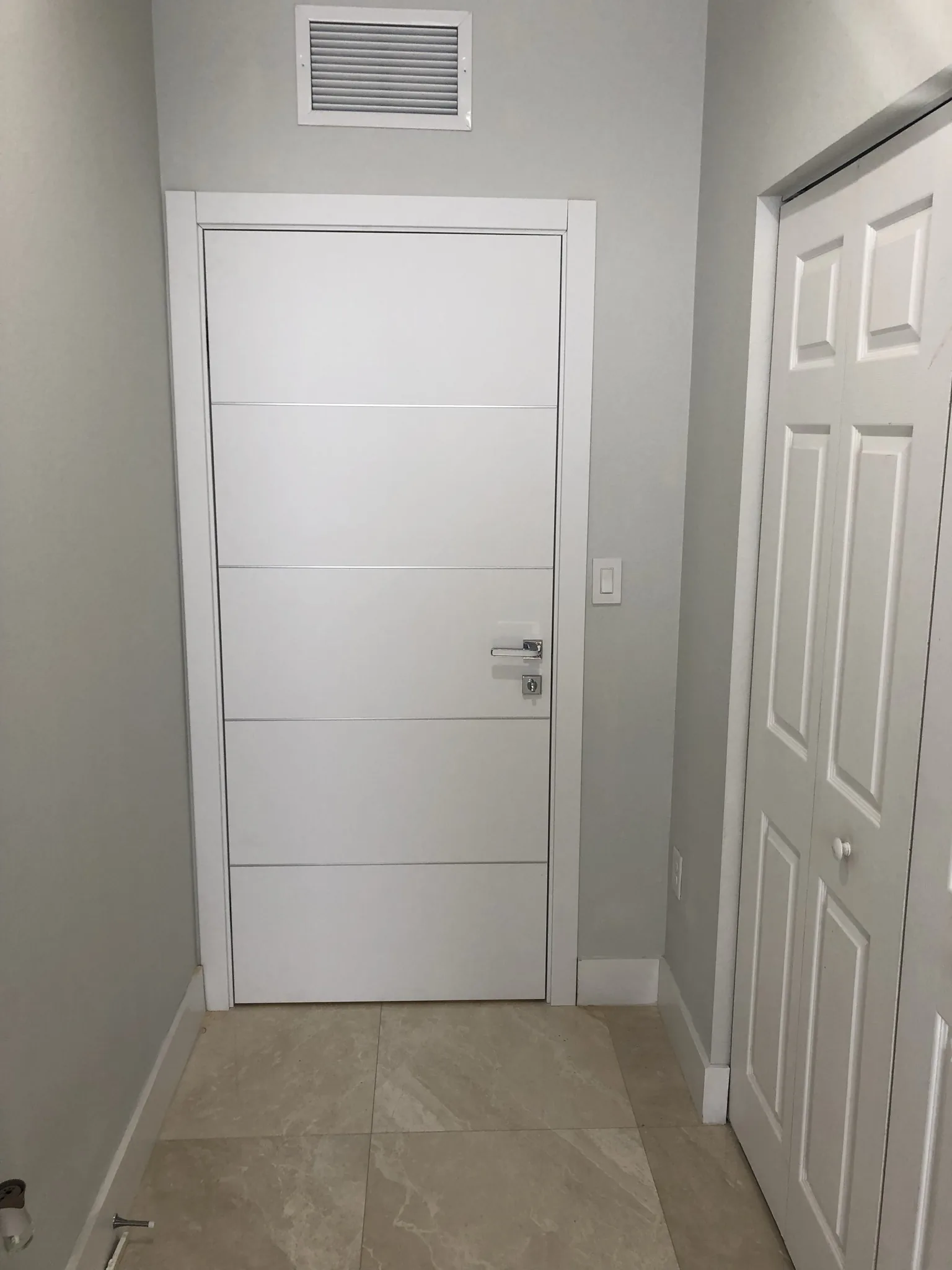 White door with horizontal grooves — interior door supplied and installed by Slab & Trim