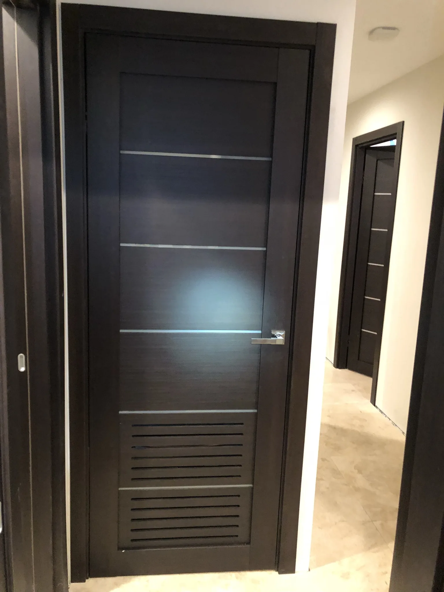 Wenge door with a louvered vent panel — interior door supplied and installed by Slab & Trim