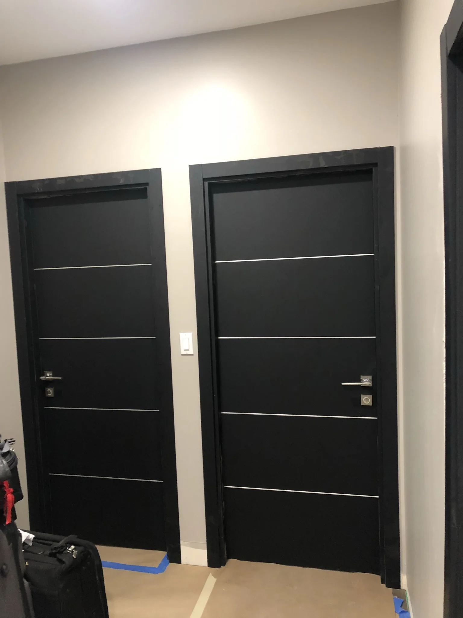Black woodgrain double doors with aluminum inlays — interior door supplied and installed by Slab & Trim