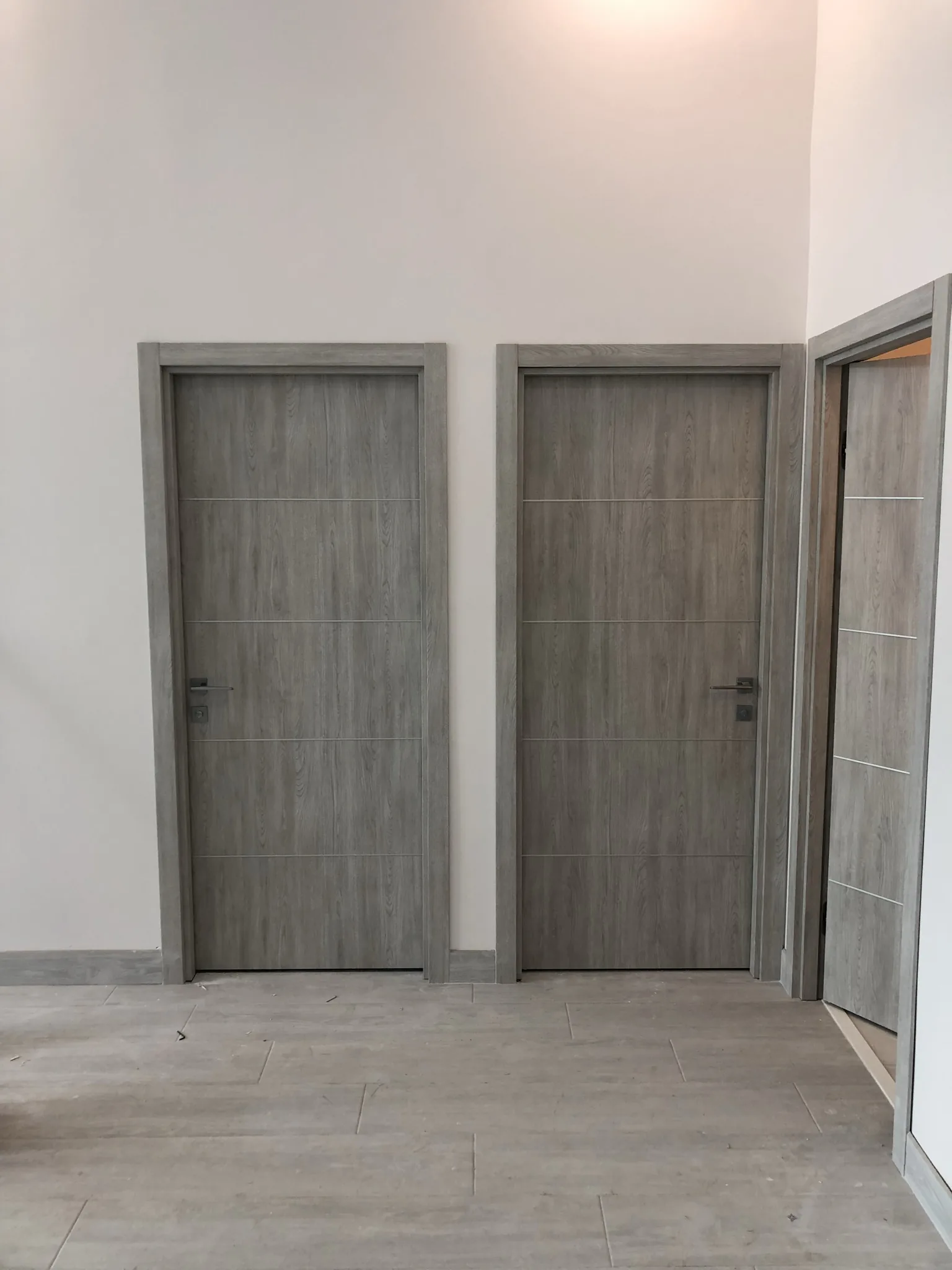 Grey woodgrain doors with aluminum inlays — interior door supplied and installed by Slab & Trim