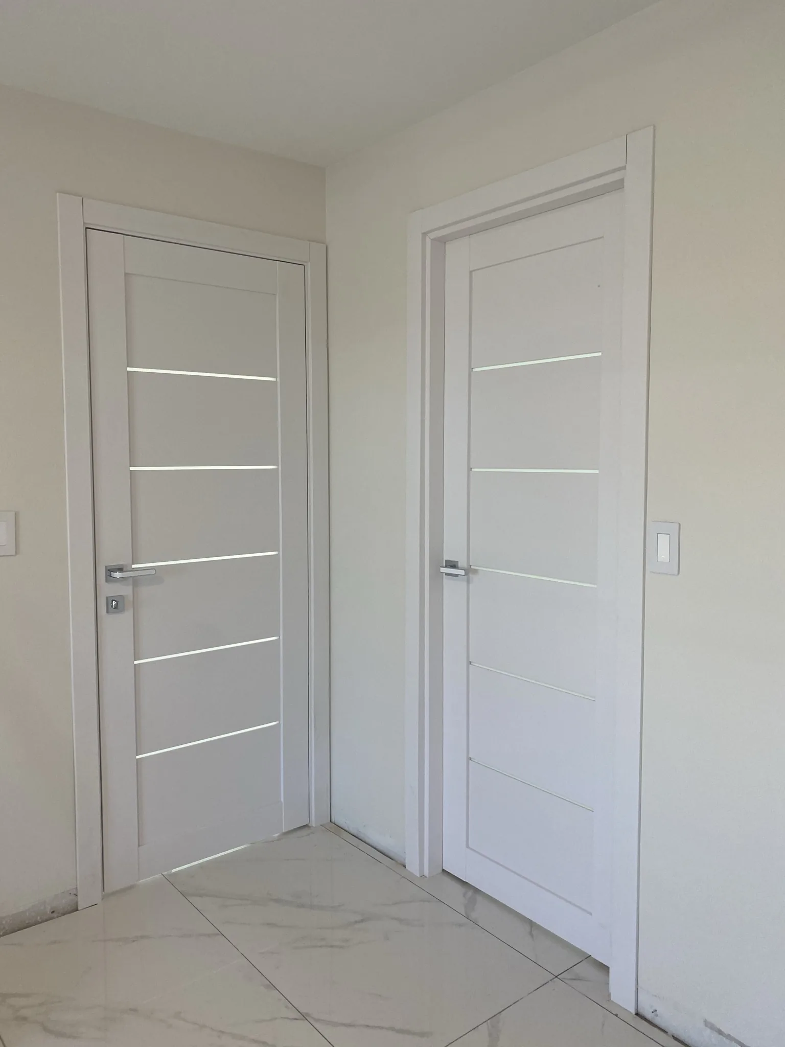 White doors with slim aluminum inlays — interior door supplied and installed by Slab & Trim