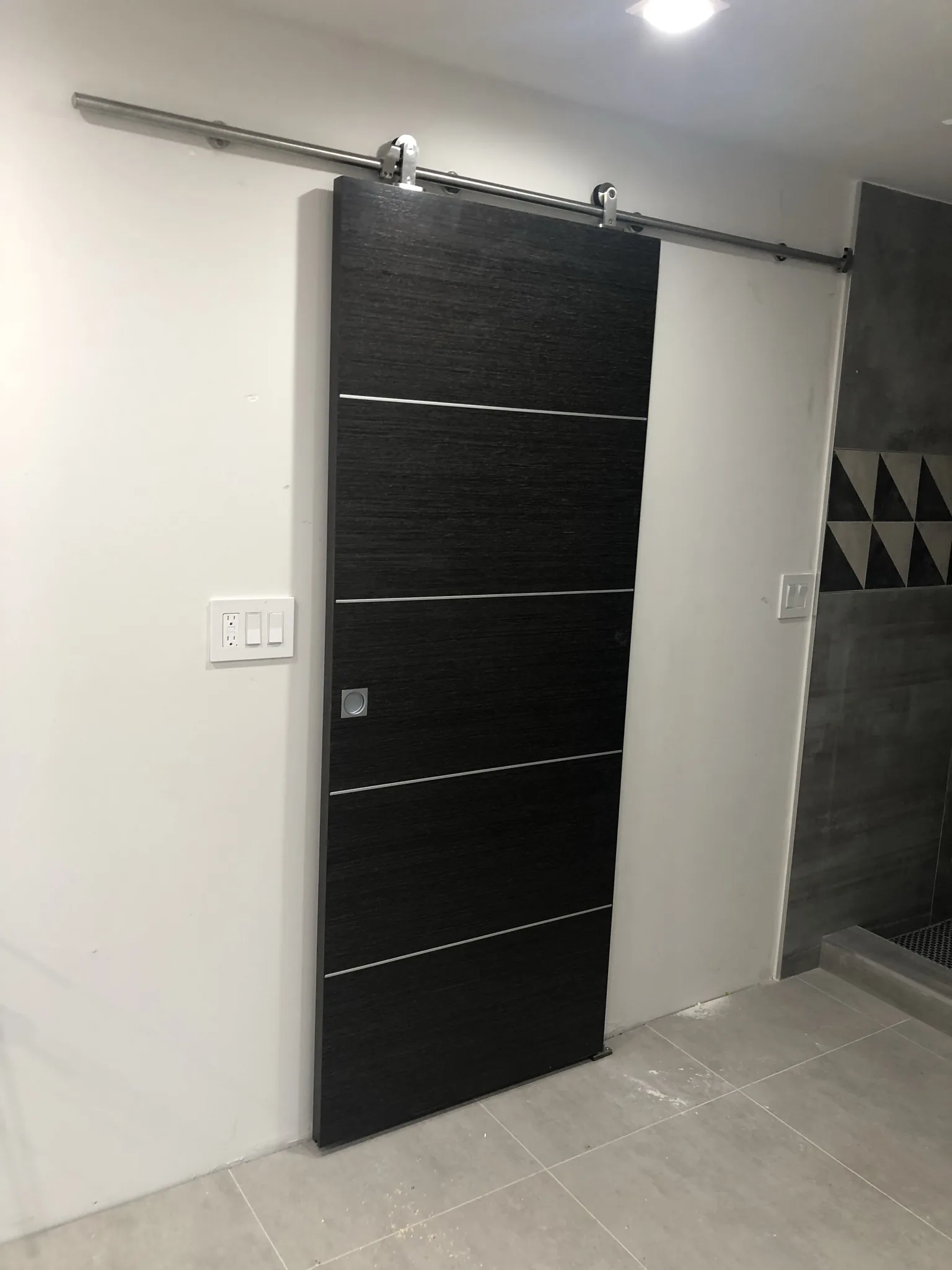 Wenge barn door on a stainless steel rail — interior door supplied and installed by Slab & Trim