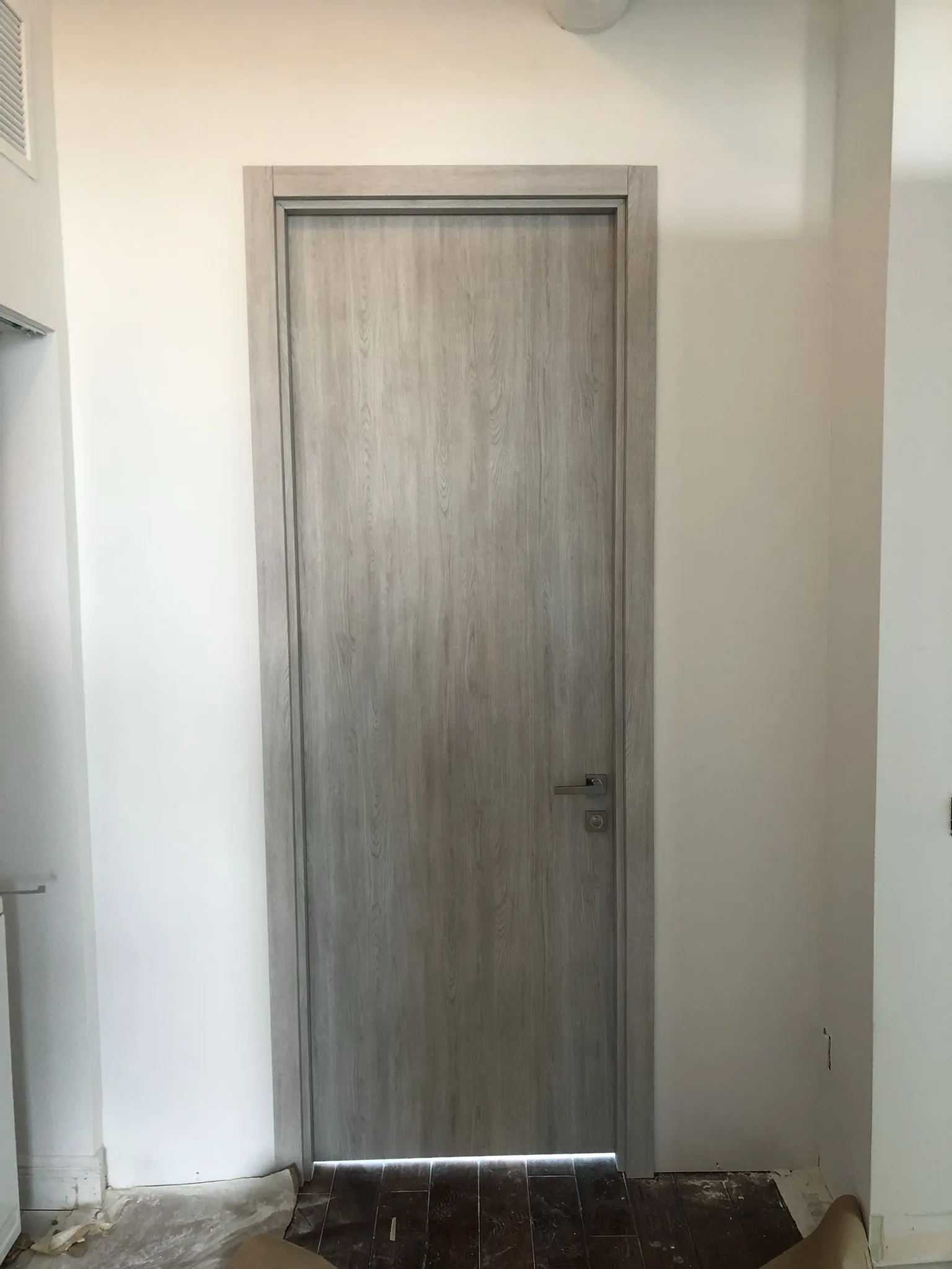Grey woodgrain flush door — interior door supplied and installed by Slab & Trim